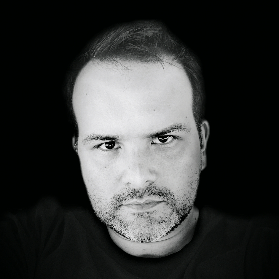 A stylised black and white headshot photo of Chris