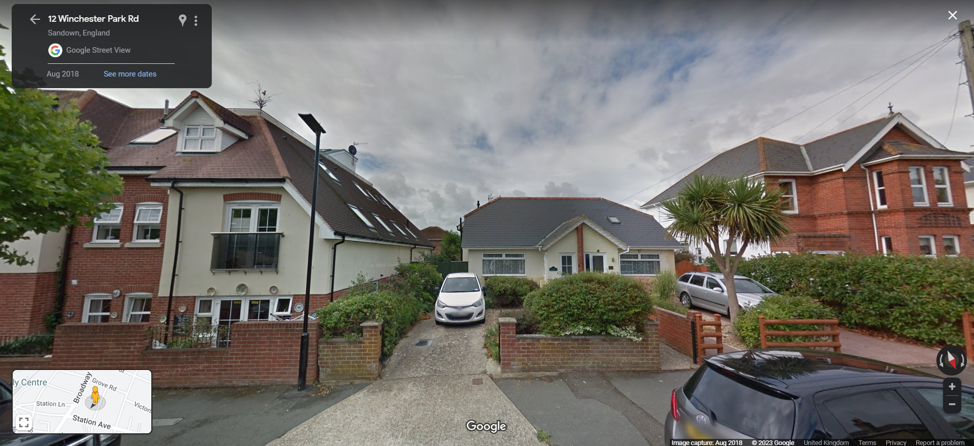 A screenshot from Google StreetView showing, from right to left, the house with the stripe, a bungalow, and a new build home.